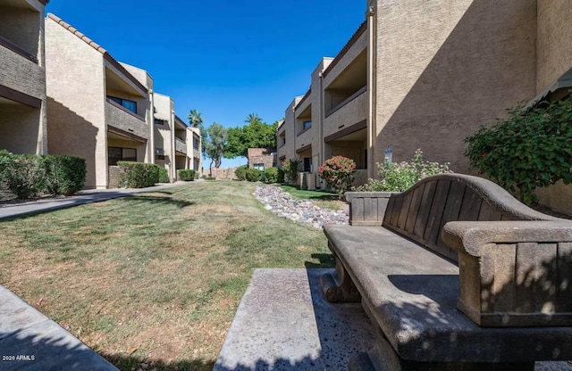 view of home's community featuring a lawn