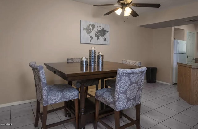 dining space with light tile floors and ceiling fan
