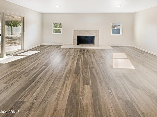 unfurnished living room featuring a high end fireplace and wood-type flooring