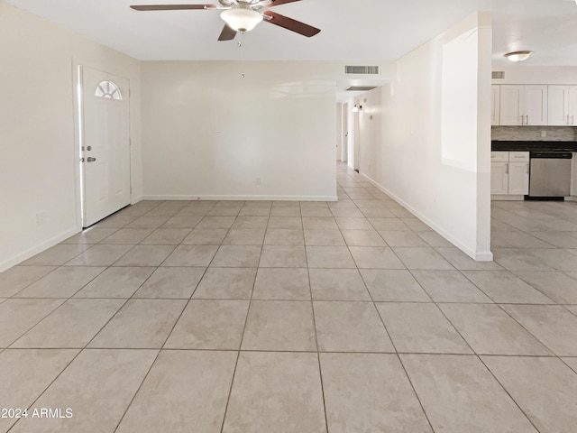 tiled spare room with ceiling fan