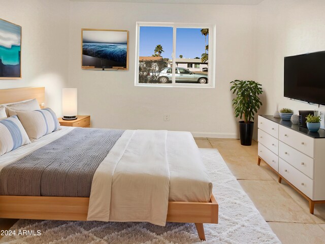 bedroom with light tile patterned floors