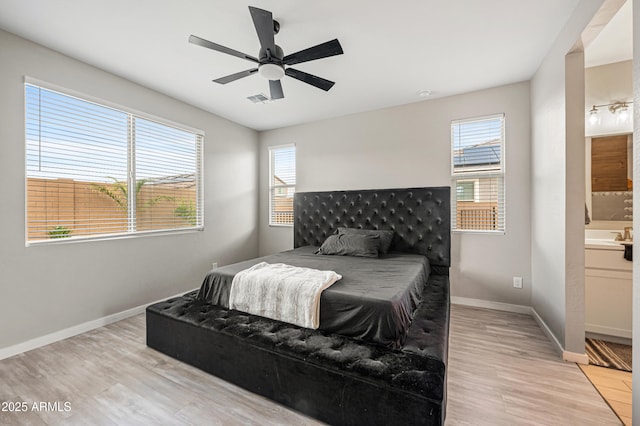 17968 W Hilton Ave, Goodyear, AZ 85338 - bedroom featuring light wood-style floors, baseboards, connected bathroom, and ceiling fan