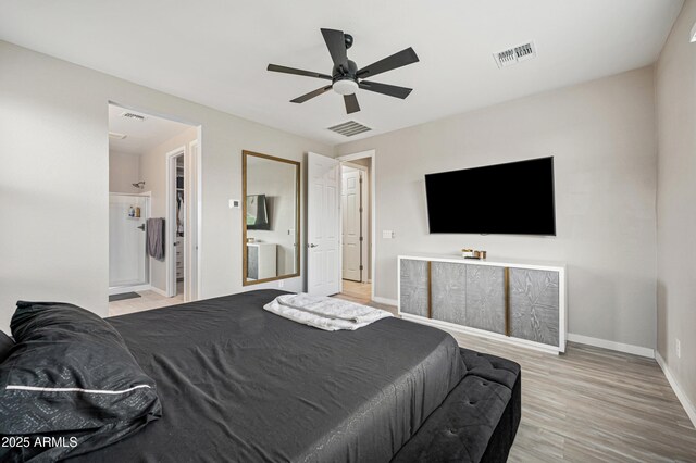 17968 W Hilton Ave, Goodyear, AZ 85338 - bedroom with wood finished floors, baseboards, a ceiling fan, and connected bathroom