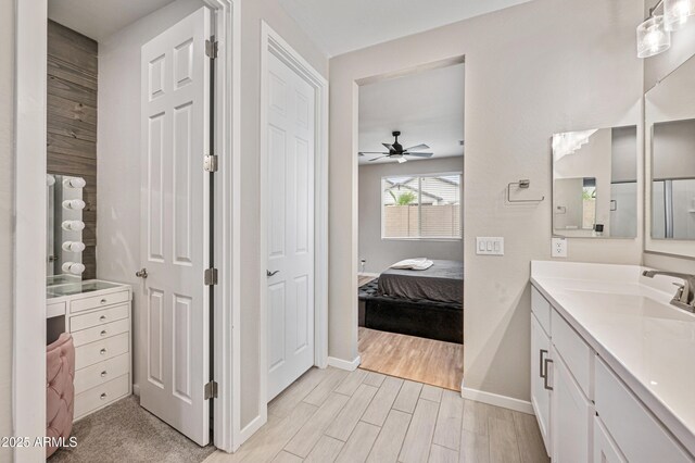 17968 W Hilton Ave, Goodyear, AZ 85338 - ensuite bathroom with vanity, a ceiling fan, baseboards, and wood finished floors