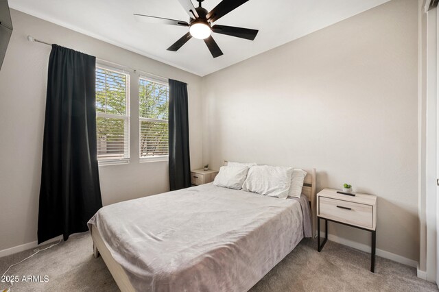 17968 W Hilton Ave, Goodyear, AZ 85338 - bedroom featuring baseboards, light carpet, and a ceiling fan