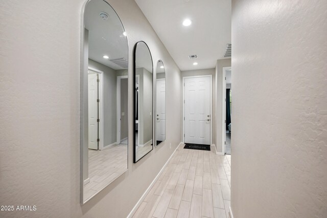 17968 W Hilton Ave, Goodyear, AZ 85338 - corridor with light wood-style flooring, arched walkways, recessed lighting, and baseboards