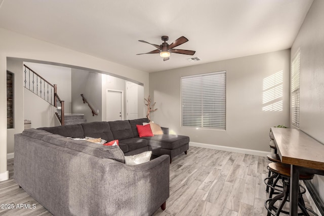 living room with ceiling fan and light hardwood / wood-style floors