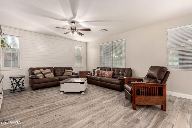 living room with ceiling fan and light wood-type flooring