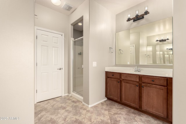 bathroom with vanity, tile patterned flooring, and a shower with shower door