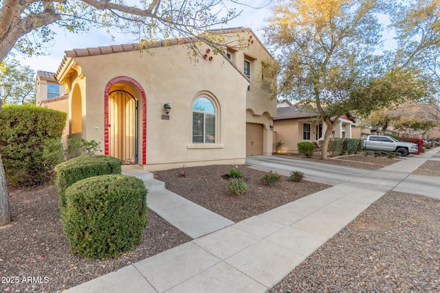 mediterranean / spanish-style home with a garage