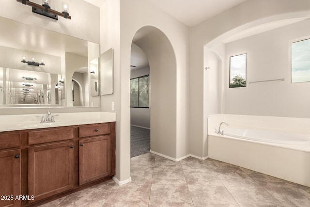 bathroom with tile patterned floors, vanity, and a bathing tub