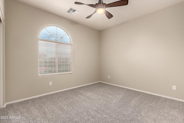 carpeted spare room featuring ceiling fan