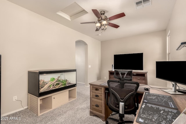 carpeted home office featuring ceiling fan