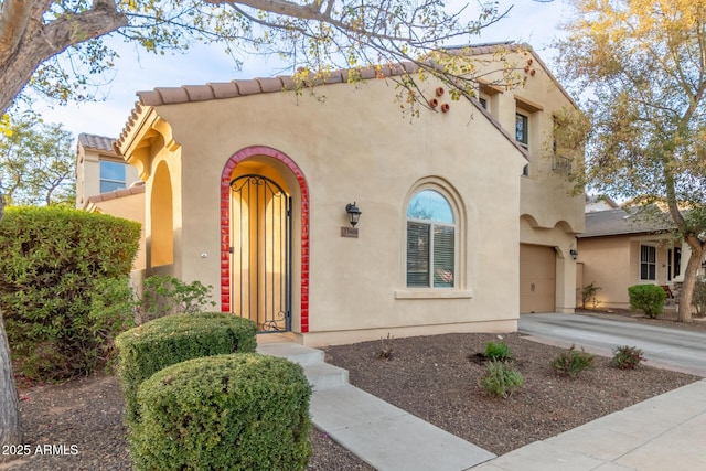 mediterranean / spanish-style house with a garage