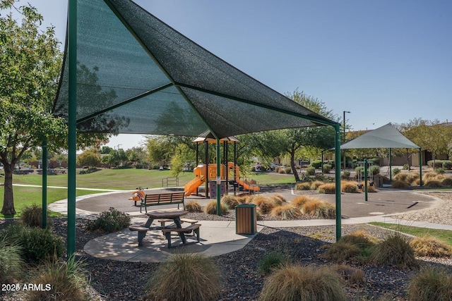 surrounding community featuring a playground and a lawn