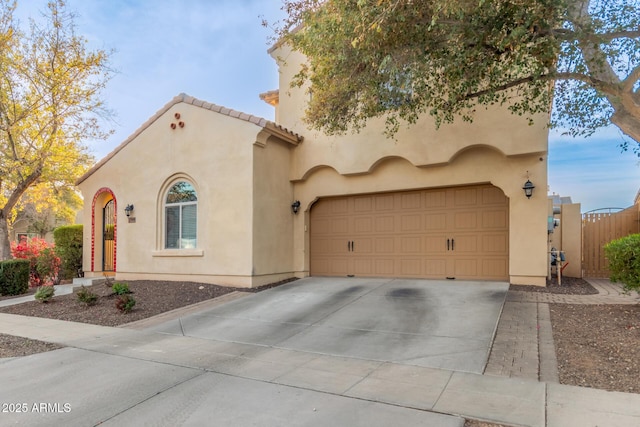 mediterranean / spanish-style house with a garage