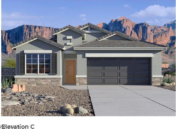 view of front of home with a mountain view and a garage