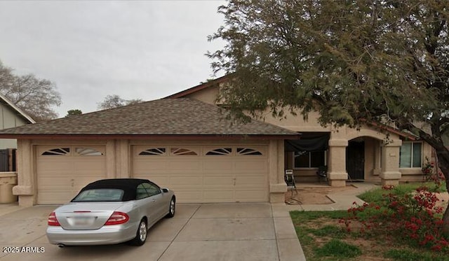 view of front of property with an attached garage, driveway, and roof with shingles