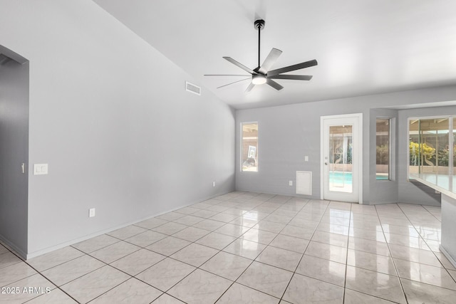 spare room with light tile patterned floors, ceiling fan, lofted ceiling, and visible vents