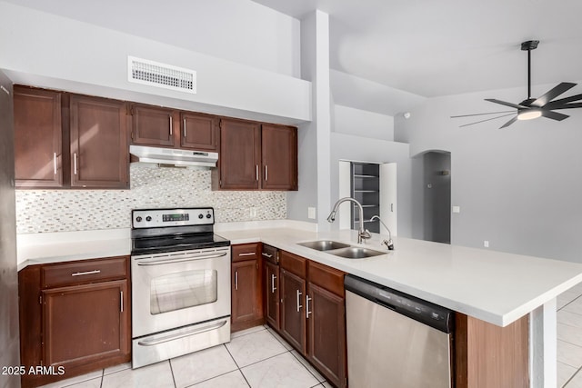 kitchen featuring stainless steel appliances, visible vents, a sink, a peninsula, and under cabinet range hood