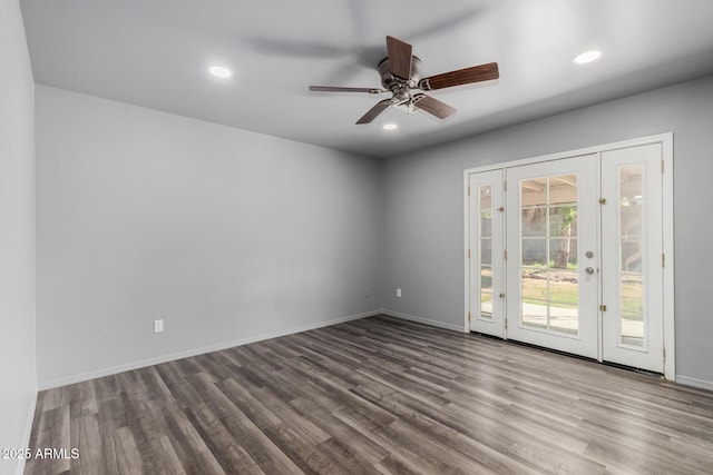 empty room featuring baseboards, wood finished floors, a ceiling fan, and recessed lighting