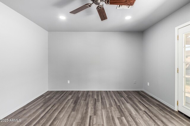 unfurnished room with recessed lighting, wood finished floors, and baseboards