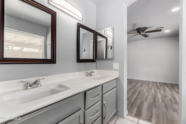 bathroom with ceiling fan, double vanity, a sink, and visible vents