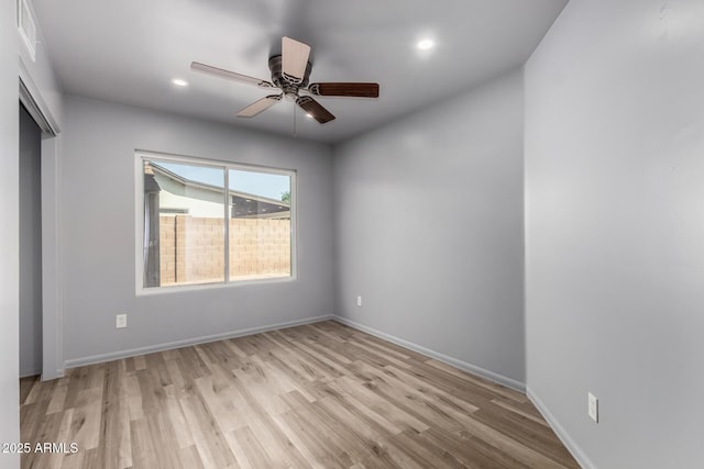 empty room featuring recessed lighting, wood finished floors, visible vents, a ceiling fan, and baseboards