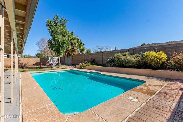 view of pool with a patio area and a fenced backyard