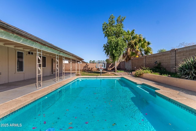 view of swimming pool featuring a fenced in pool, a patio area, and a fenced backyard