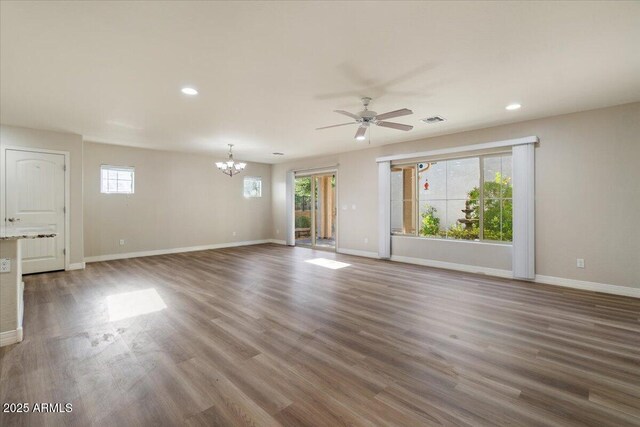 2868 E Binner Dr, Chandler, AZ 85225 - unfurnished living room with a chandelier, a ceiling fan, baseboards, wood finished floors, and recessed lighting