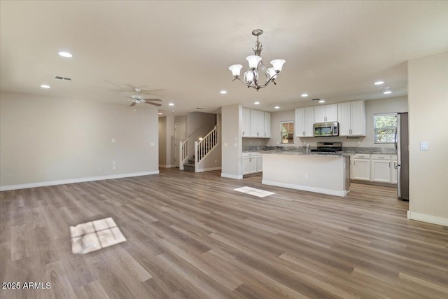 2868 E Binner Dr, Chandler, AZ 85225 - kitchen featuring stainless steel appliances, open floor plan, white cabinetry, recessed lighting, and light wood-style floors