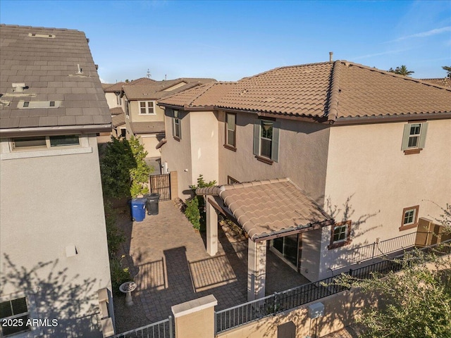 2868 E Binner Dr, Chandler, AZ 85225 - rear view of house with a tile roof, stucco siding, and fence