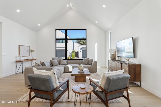 living room featuring light hardwood / wood-style flooring and high vaulted ceiling