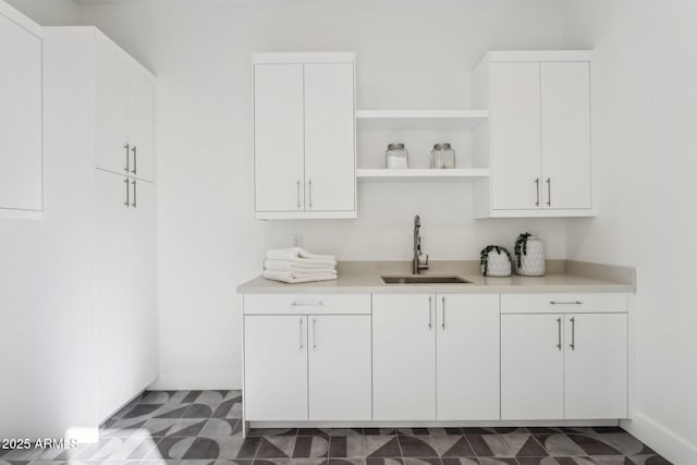 bar with sink and white cabinets