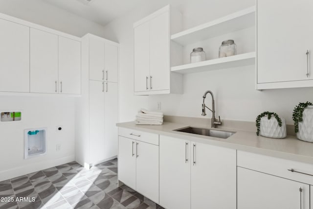 laundry area with cabinets, sink, and hookup for an electric dryer