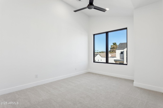 carpeted spare room featuring ceiling fan and high vaulted ceiling