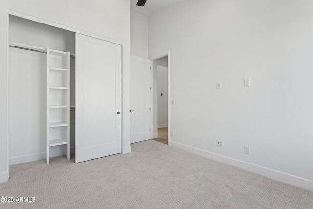 unfurnished bedroom featuring light colored carpet and ceiling fan