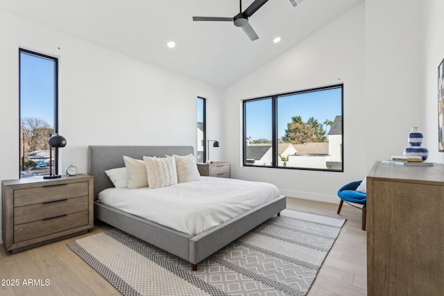 bedroom featuring high vaulted ceiling, light hardwood / wood-style floors, and ceiling fan