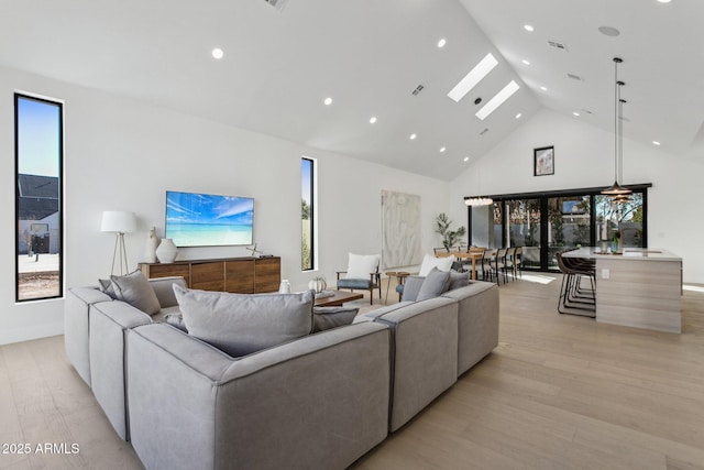 living room featuring high vaulted ceiling and light wood-type flooring