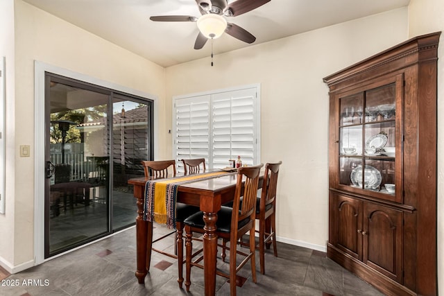 dining area with a ceiling fan and baseboards