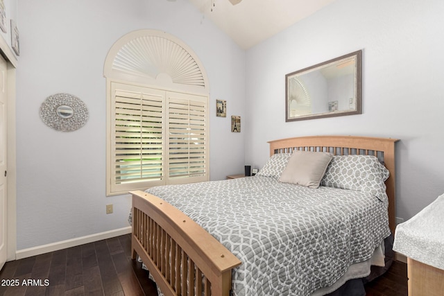 bedroom featuring baseboards, vaulted ceiling, and dark wood-type flooring