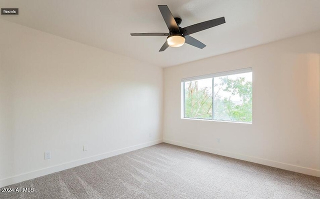 spare room with carpet and ceiling fan