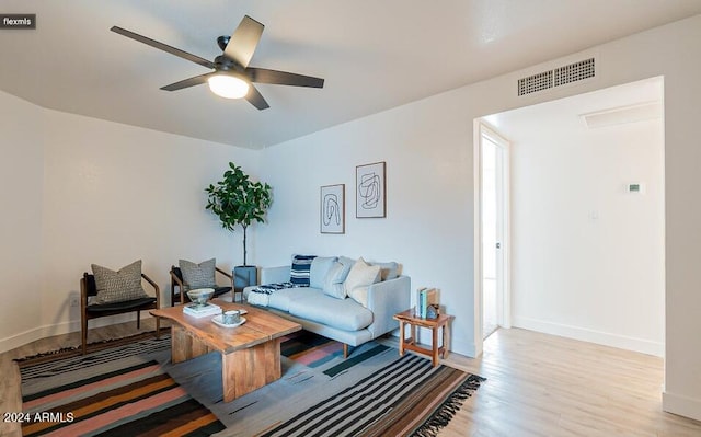 living room featuring ceiling fan and light hardwood / wood-style flooring