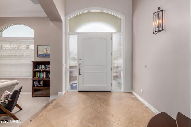 foyer featuring baseboards