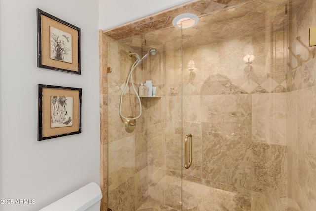 full bath featuring a shower stall and toilet