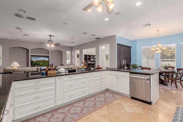 kitchen with a sink, visible vents, open floor plan, and stainless steel dishwasher