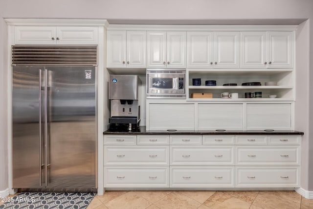 kitchen featuring light tile patterned floors, white cabinetry, open shelves, and built in appliances