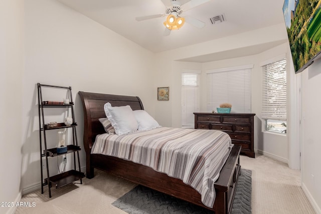 bedroom with light carpet, a ceiling fan, visible vents, and baseboards