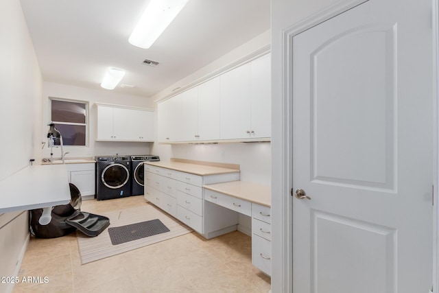 laundry room featuring cabinet space, washing machine and dryer, light tile patterned floors, and visible vents